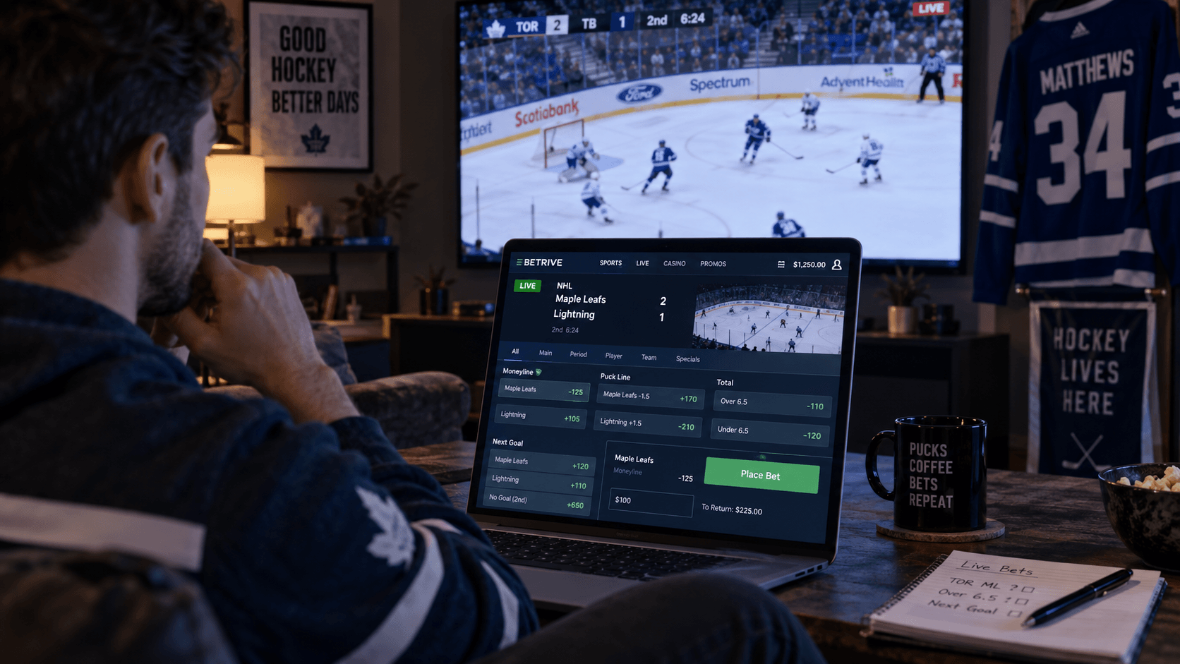 Person watching an ice hockey game on TV while placing a live hockey bet on a laptop, with NHL betting odds and markets displayed on screen.